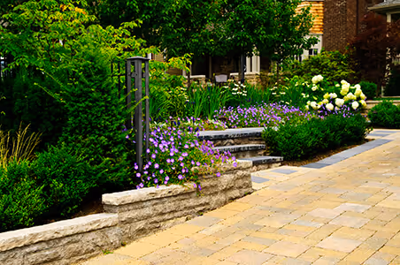 Photo of a stone retailing, beautiful landscaping, and a stone drive/walkway