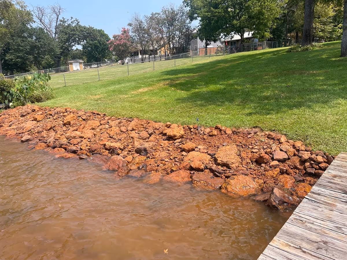 Photo of a lawn being watered by a sprinkler