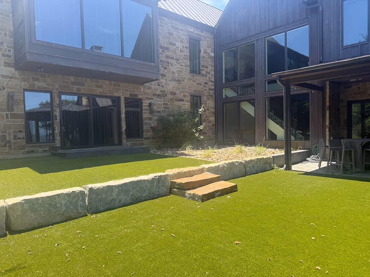 Photo of a lawn being watered by a sprinkler